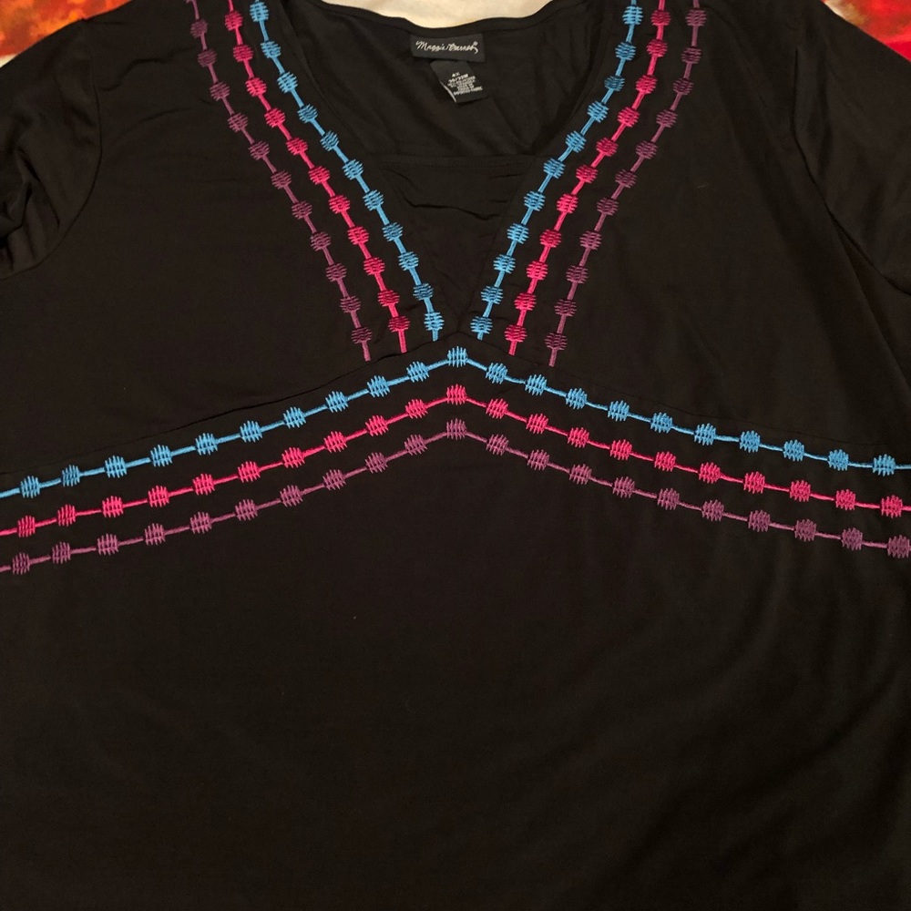 Maggie Barnes black top 4X with pink and blue embroidery.